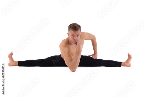 A handsome young man with an athletic body is doing fitness and yoga. White background.