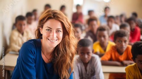White smiling Caucasian woman teaching African happy children in school class.