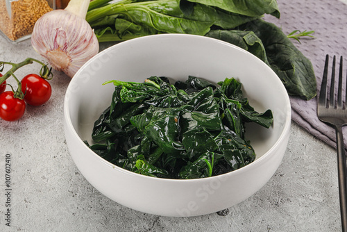 Coocked green spinach with oil photo