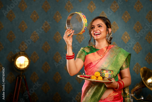 Happy Wife In Saree Holding Pooja Plate In Hand During Karva Chauth Festival

