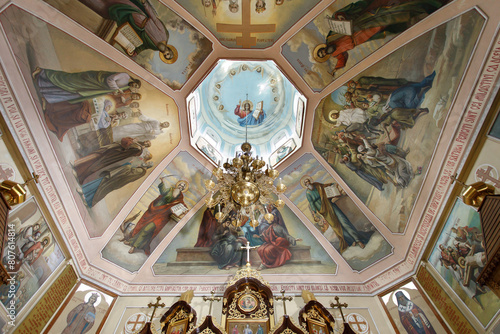 a ceiling with paintings and a clock photo