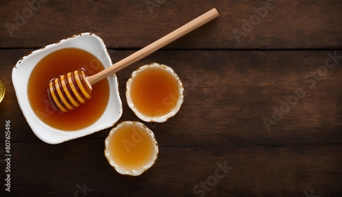 Golden Honey in a White Bowl with Dipper on Wooden Table, Copy Space