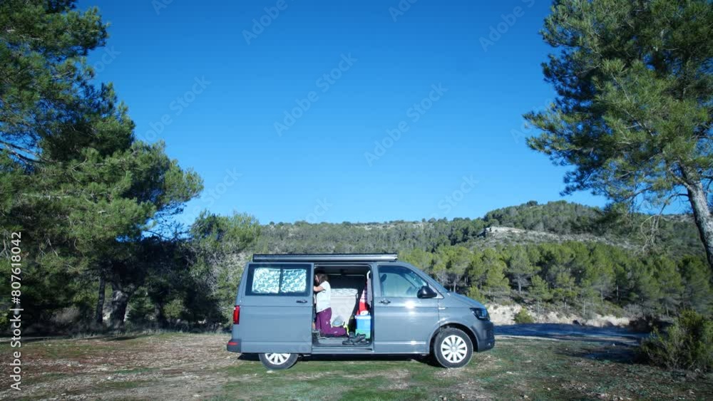 Woman in campervan at morning in nature. High quality 4k footage Woman in campervan at morning in nature. High quality 4k footage