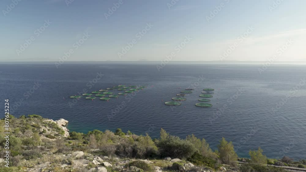 Aquaculture Round Fish Cages In The Gulf of Aegina In Greece. - wide shot Aquaculture Round Fish Cages In The Gulf of Aegina In Greece. - wide shot