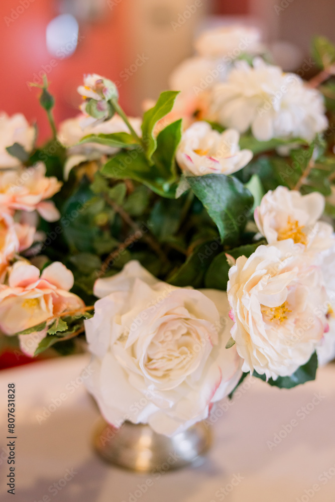 A beautiful bouquet of flowers on a white tablecloth table A beautiful bouquet of flowers on a white tablecloth table