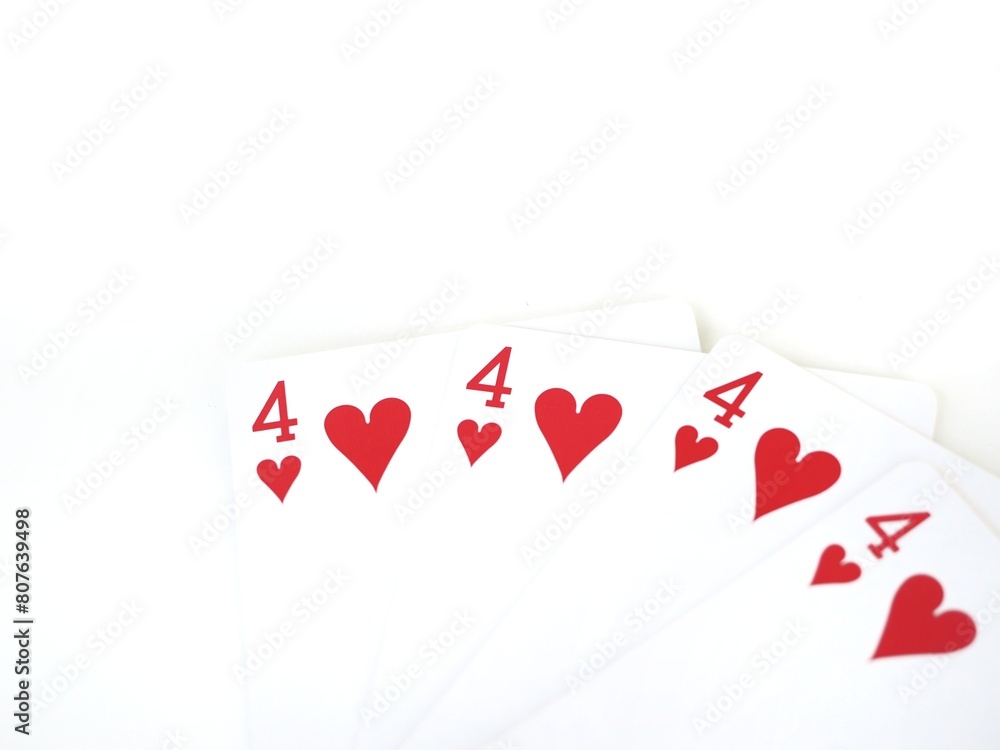 Close-up of four identical poker cards with the four of hearts isolated on a white background and space for text