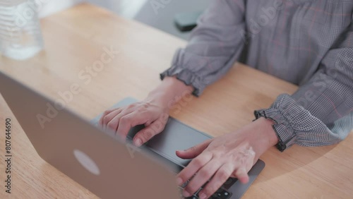 Close-up of a woman's hand using an important laptop Female hands typing on laptop computer working online photo