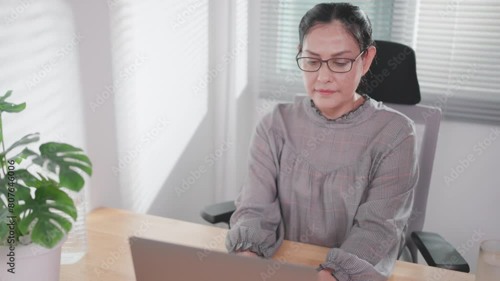 Asian woman using laptop at home, independent users working with laptop, typing messages online, studying with computer at home, talking about business. Asian woman using laptop at home, independent users working with laptop, typing messages online, studying with computer at home, talking about business.