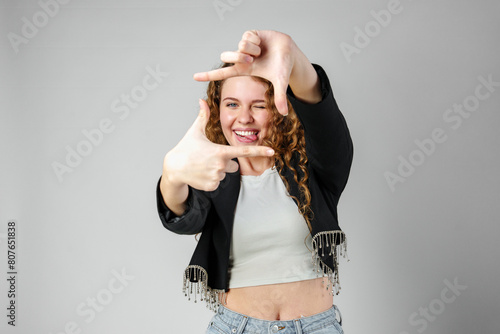 Woman Making Hand Gesture Picture Frame in Studio