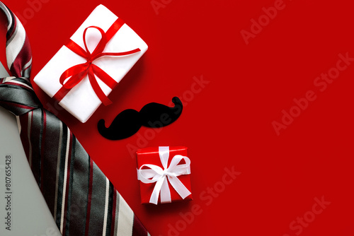 Happy Father's Day. Top view of necktie,gift boxes with red bow and false mustache with copy space for text photo