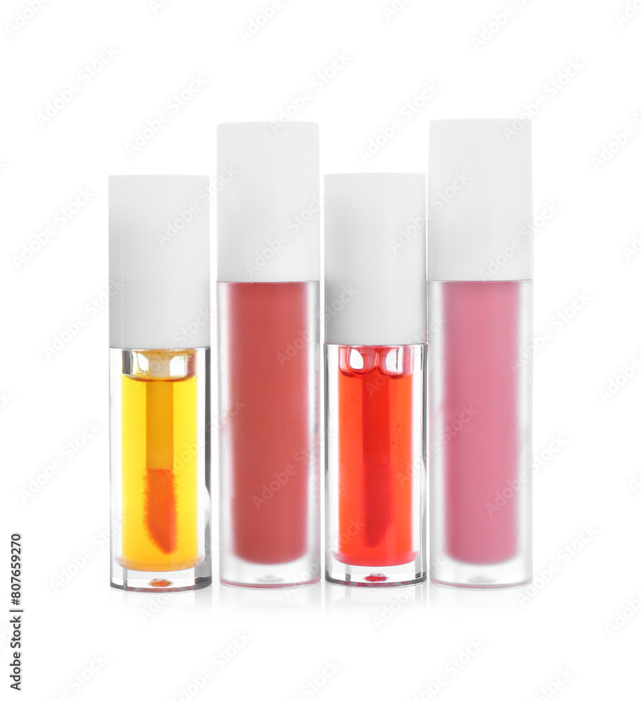 Many different lip glosses isolated on white Many different lip glosses isolated on white