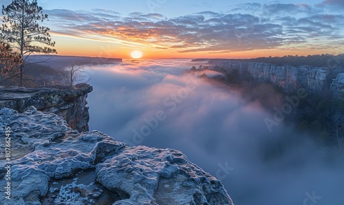 Fog envelopes the Little River Canyon National Preserve at sunrise from a high sandstone cliff, Fort Payne, Alabama. Panorama. photo