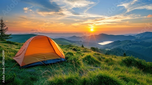 An orange tent pitched up on the peak of a mountain under clear skies © Hryhor Denys