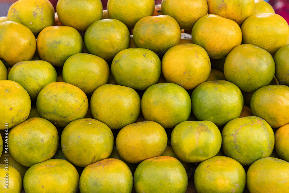 ripe tangerines with green peel as background. ripe tangerines with green peel as background.