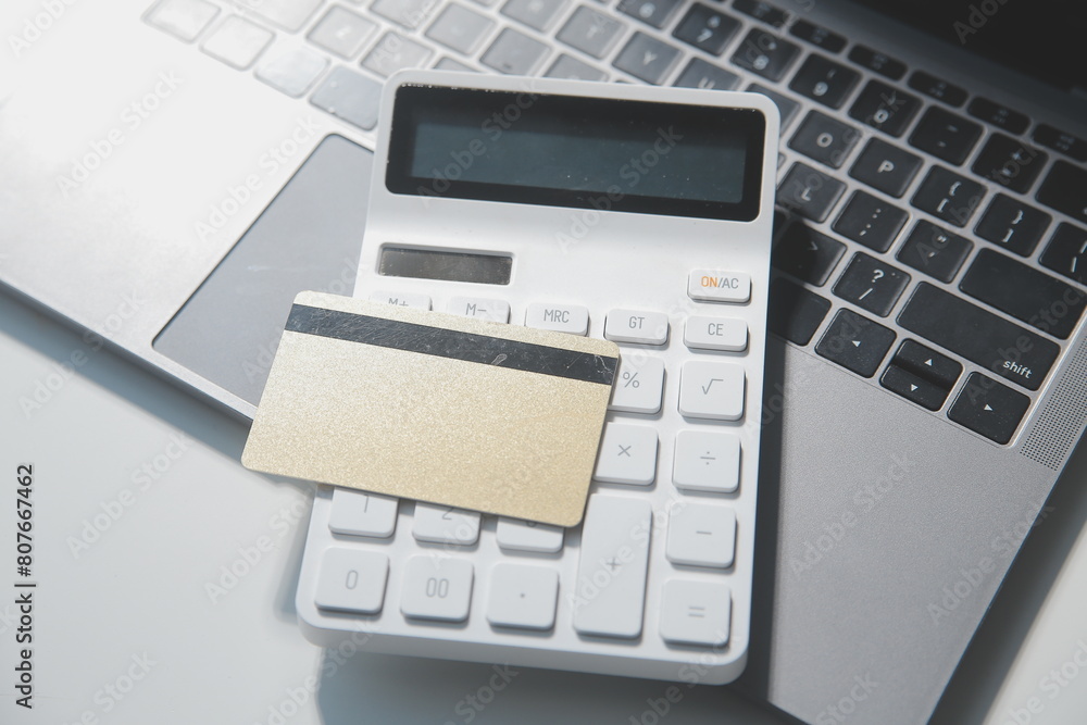 Calculator on a dark background, plastic cards and banknotes Calculator on a dark background, plastic cards and banknotes