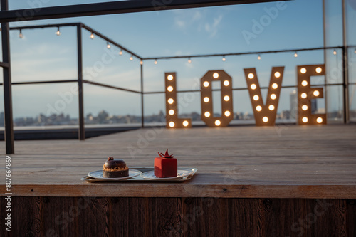 Two cakes on a background of "love". Romantic mini cakes