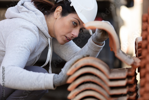 female bricklayer working with brick blocks