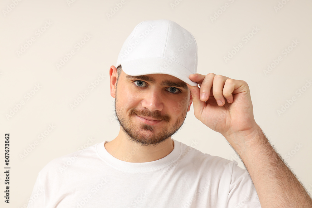 A young guy in a white T-shirt on a light background A young guy in a white T-shirt on a light background