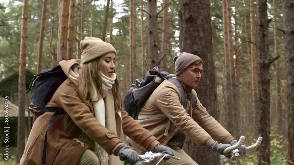 cinematic slow motion video of a young couple cycling vintage bikes through the woodland countryside during a cloudy and overcast day. cinematic slow motion video of a young couple cycling vintage bikes through the woodland countryside during a cloudy and overcast day.