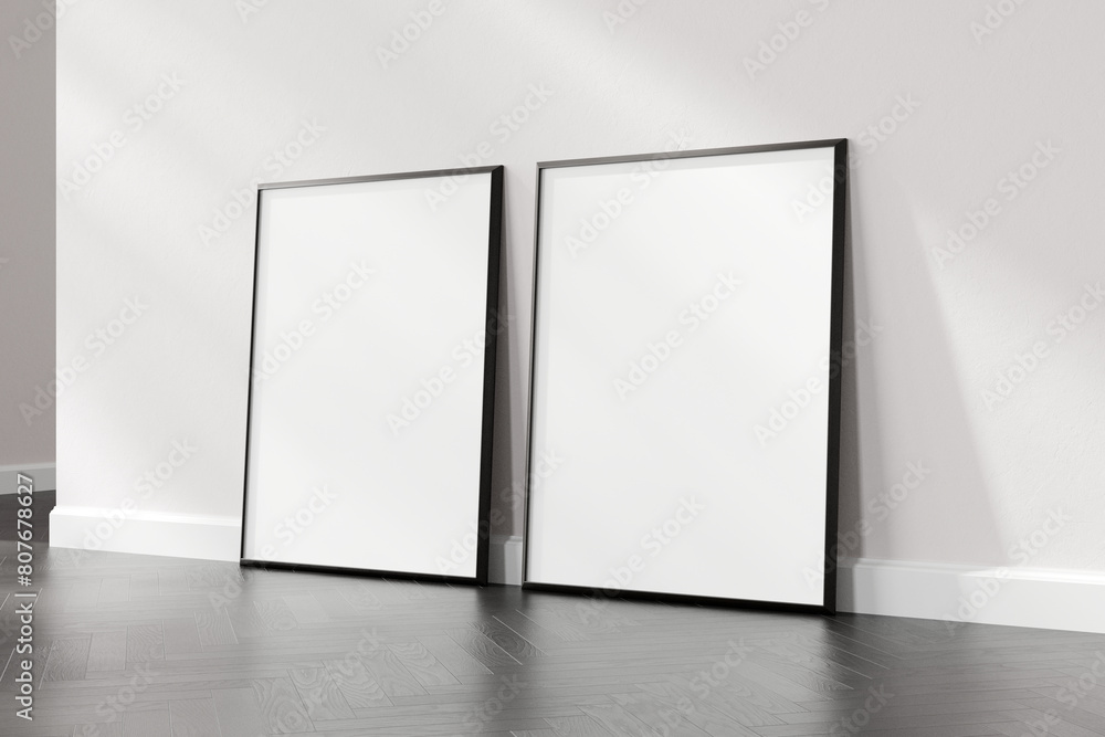 Two empty picture frames resting on a wooden floor against a white wall, suitable for art display or mockup design, 3d render. Two empty picture frames resting on a wooden floor against a white wall, suitable for art display or mockup design, 3d render.