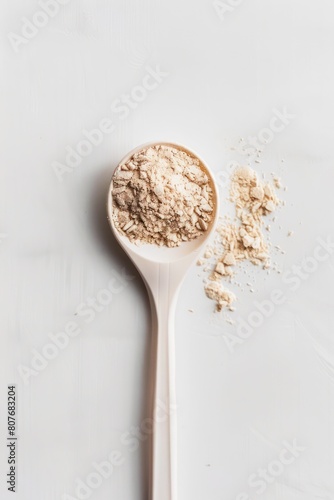 Plastic spoon filled with plant-derived keto protein powder on an isolated background. Space to copy additional text or design elements