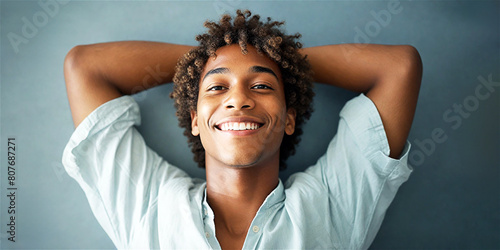 Headshot of an attractive, satisfied black male student. Young Afro-American man looking into the camera smiling and with a proud and calm expression on his face. photo