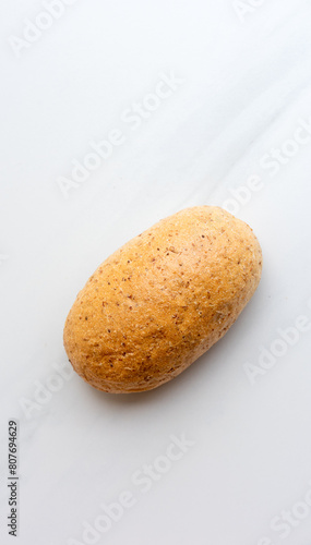 fresh baked roll (bun) on a white
