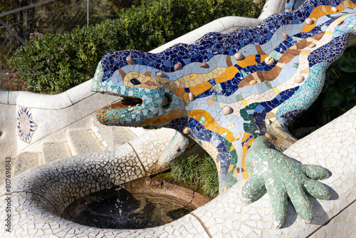 Multicolored mosaic of Salamander or Dragon. Lizard Fountain at Park Guell, popular touristic objects in Barcelona, Spain. Multicolored mosaic of Salamander or Dragon. Concept of tourism and vacation