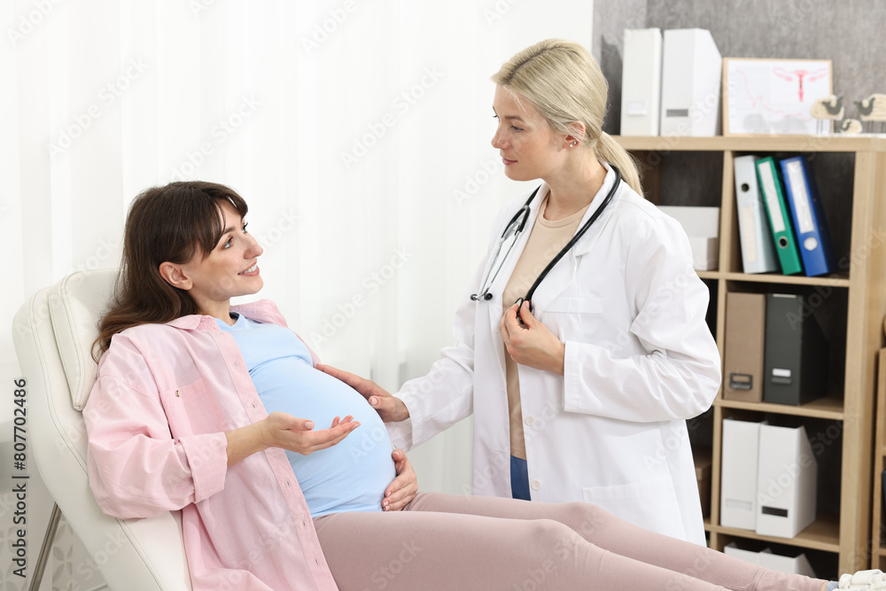 Happy pregnant woman having doctor appointment in hospital Happy pregnant woman having doctor appointment in hospital