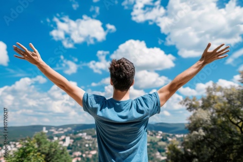 Man Celebrating on Mountain Top with Arms Raised  Victory  Freedom  Outdoor Adventure