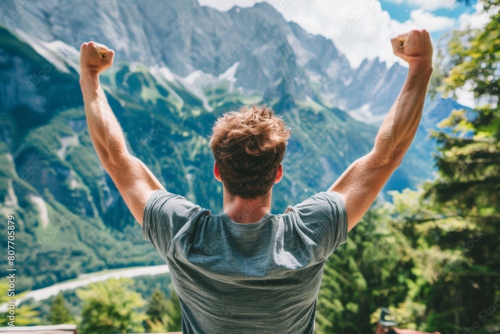Man Celebrating on Mountain Top with Arms Raised, Victory, Freedom, Outdoor Adventure Man Celebrating on Mountain Top with Arms Raised, Victory, Freedom, Outdoor Adventure