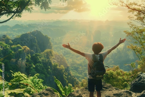 boy Celebrating on Mountain Top with Arms Raised  Victory  Freedom  Outdoor Adventure