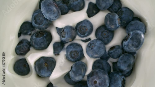 Super Slow Motion Shot of Fresh Blueberries Followed by Camera Falling into Yogurt at 1000fps.