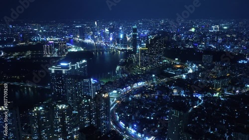 Nightlapse of Ho Chi Minh City, Saigon Vietnam at night with the view of the city center with bright lights and fast traffic timelapse