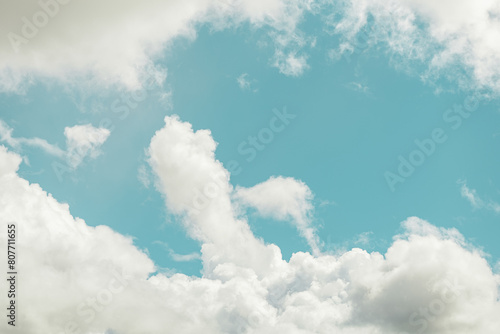 Serene blue sky with fluffy white clouds photo