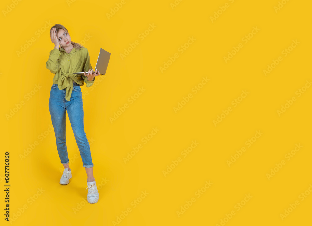 © Designerant - Unhappy young woman, full body length blonde 20s unhappy young woman holding laptop looking copy space. Irritating huffing stressed working or studying. Computer system crash concept idea image.