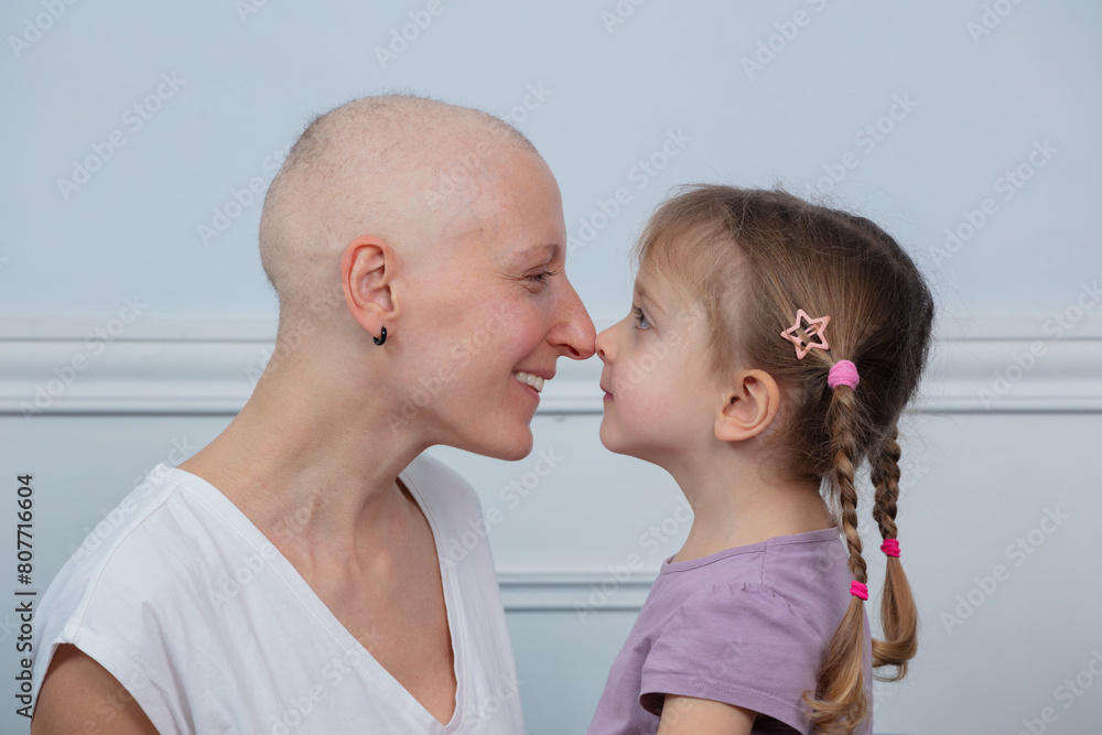 Strong woman and mother fight cancer touch noses with daughter Strong woman and mother fight cancer touch noses with daughter