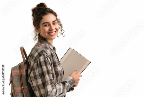 A young smiling woman student with backpack, wearing glasses, holding a book on white background