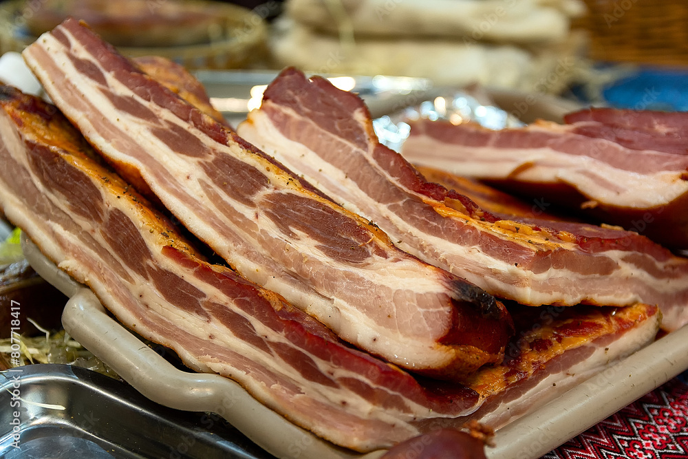 Fresh delicious bacon on the counter of the store. Food