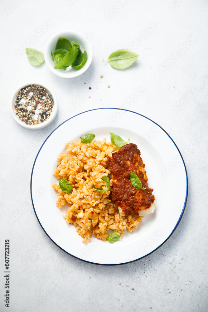 Fototapeta premium Baked white fish with pepper sauce