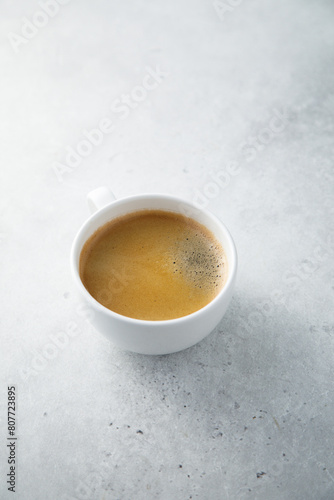 Black coffee served in a white cup