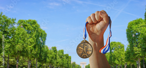 Photography French gold medal with Eiffel Tower on it, isolated on blue sky