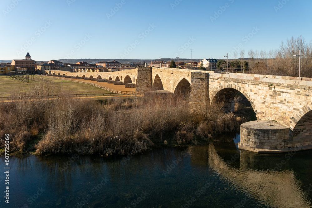 Fototapeta premium Passo Honroso stone bridge of the village of Hospital de Orbigo in the Way of Santiago. León, Castilla y León, Spain.