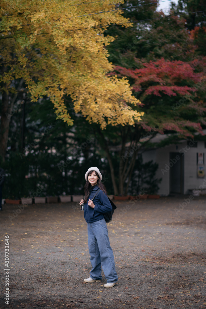 Fototapeta premium Asian woman discovers the spiritual essence of Japanese shrines and temples, radiating happiness, faith, and cultural appreciation in Tokyo and Kyoto.