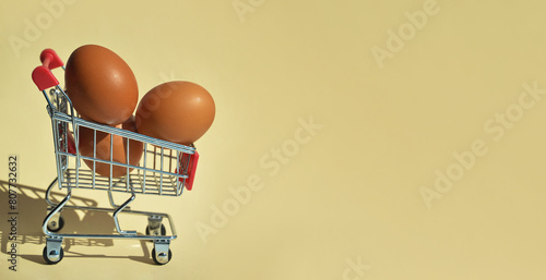eggs in the shopping basket. selling food in the store. background for the design.