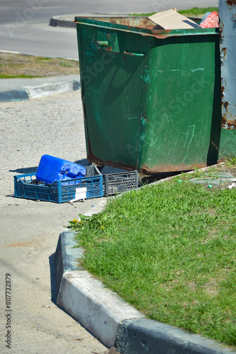 garbage can on the street of the city, pollution of nature. background for the design. © Alena Mostovich