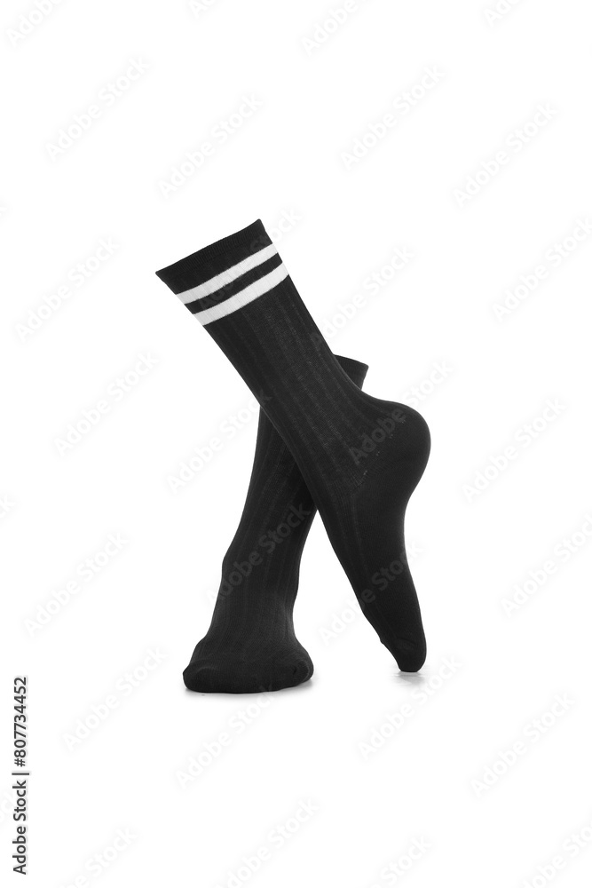Subject shot of black shadow-proof socks with two white stripes on the rim. The photo is made on the white background. Crossed legs. Subject shot of black shadow-proof socks with two white stripes on the rim. The photo is made on the white background. Crossed legs.