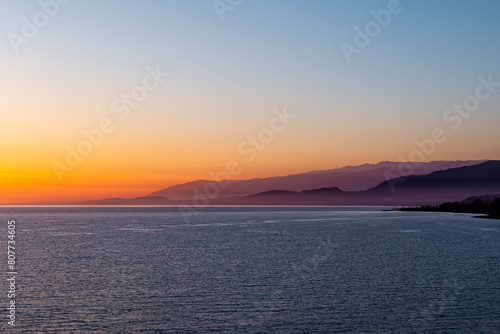 Picturesque sunset on the sea with mountain views