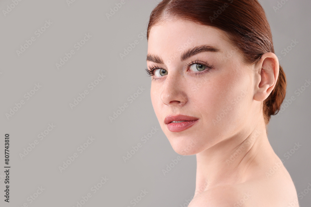 Obraz premium Portrait of beautiful woman on grey background, closeup. Space for text