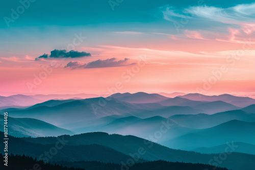 Serene landscape showcasing the breathtaking view of layered mountain ridges under a vivid sunset sky with soft clouds